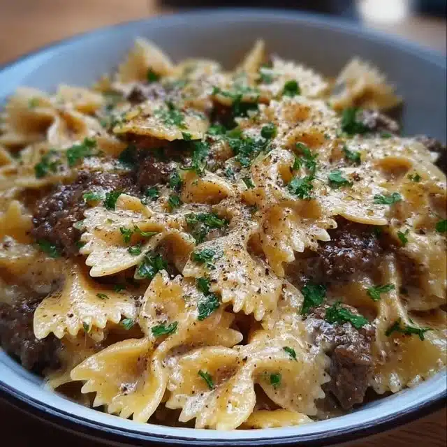Creamy Parmesan Garlic Beef Bowtie Pasta on a plate with parmesan and garlic