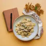 Recipe card for creamy parmesan garlic pasta with plated dish beside it