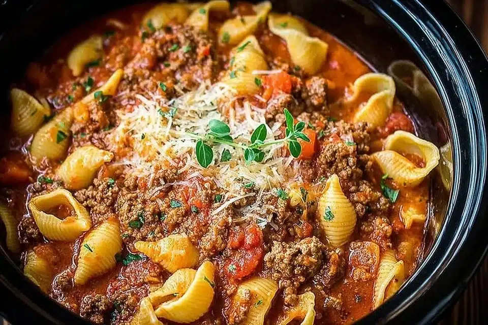 Cozy Slow Cooker Lasagna Soup in a bowl topped with cheese and basil.