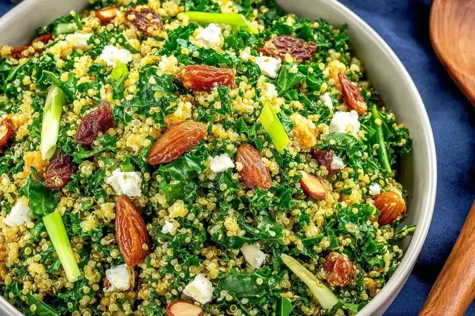 A vibrant Protein Kale Quinoa Salad topped with fresh vegetables and a light dressing.