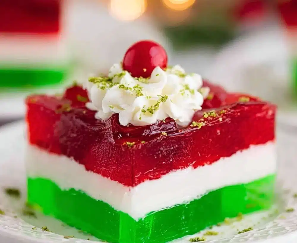 Colorful and festive Easy Layered Christmas Jello dessert served on a holiday table.