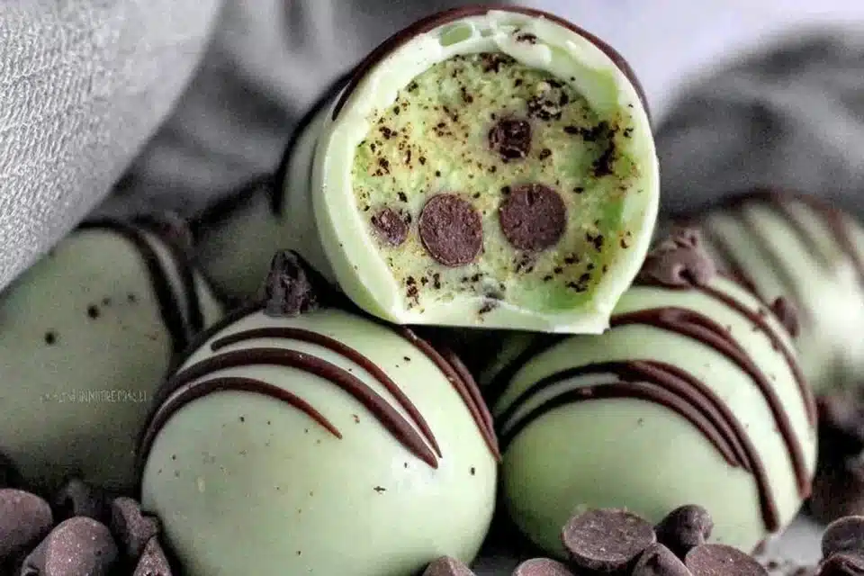 Homemade mint chocolate chip protein balls stacked in a bowl